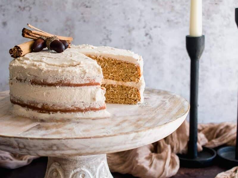Chai Cake with Vanilla Buttercream Frosting topped with cinnamon sticks.