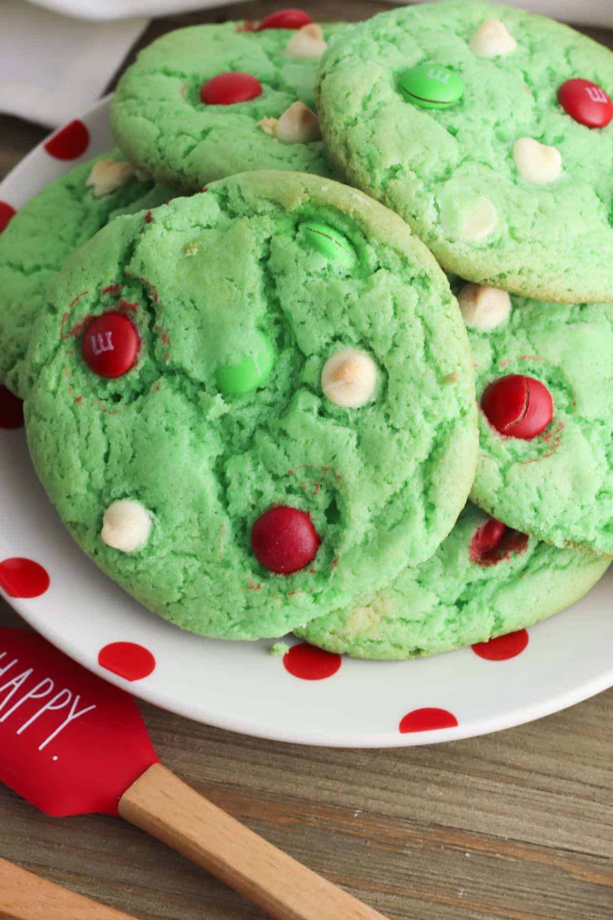 Colorful Christmas cookies with M7Ms using and red spatula.