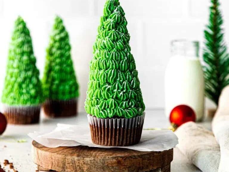 Christmas Tree Cupcakes on a wooden board.