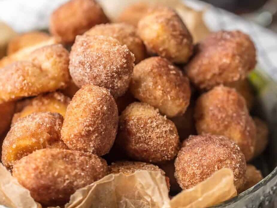 Biscuit bites in a bowl and covered in cinnamon sugar.