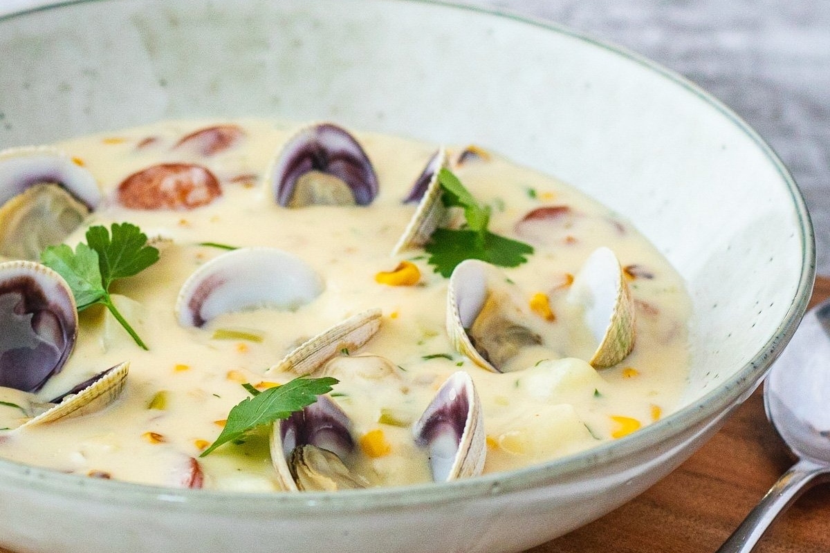 Clam chowder in white bowl.