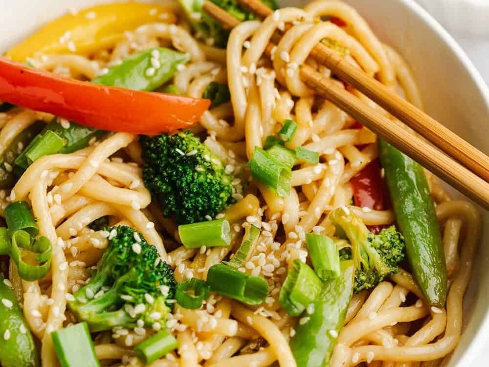 Udon noodles stir fried with broccoli, peppers and peas.