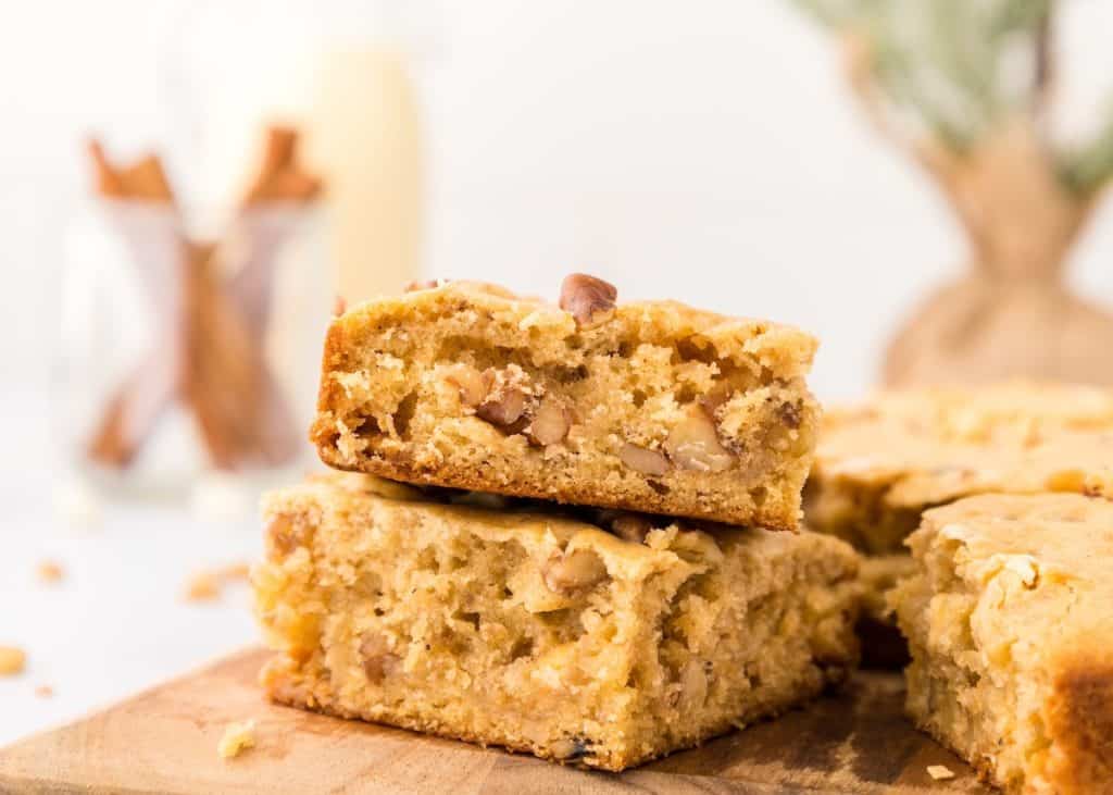 Slices of eggnog blondies on a wooden board.