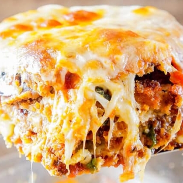 A slice of lasagna being taken out of a baking dish, showcasing delightful casserole flavors.