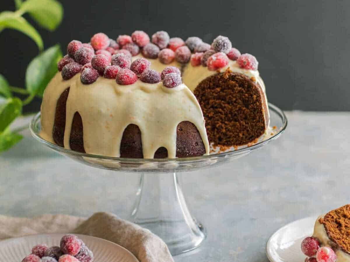 Gingerbread Bundt Cake with Cream Cheese Frosting on a cake dish.