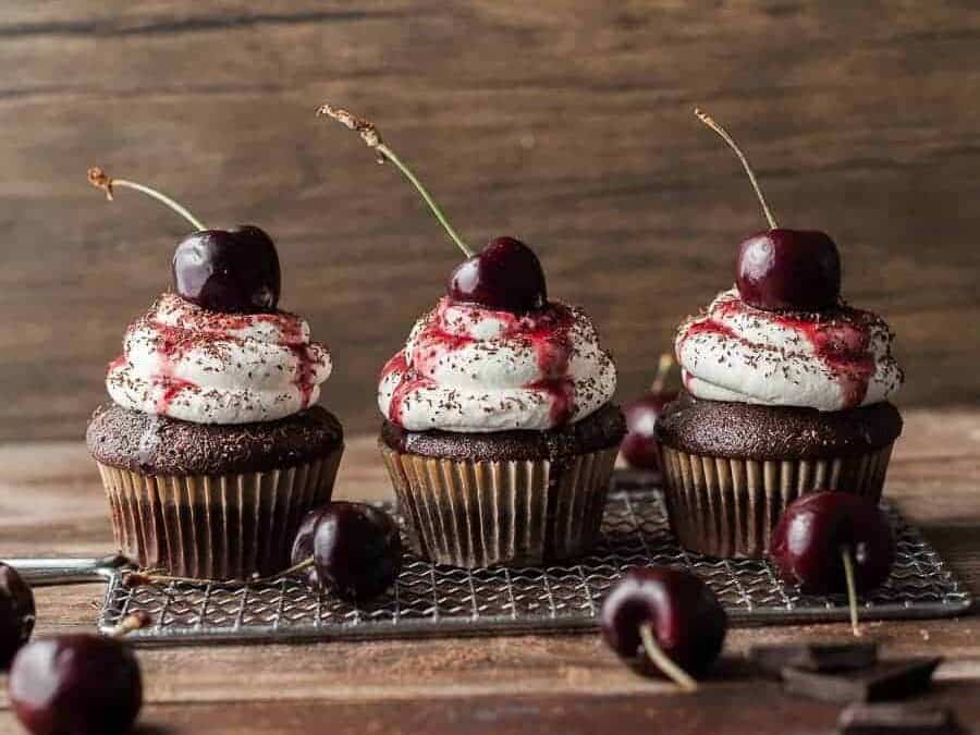 Gluten Free Black Forest Cupcakes on a cooling rack. 