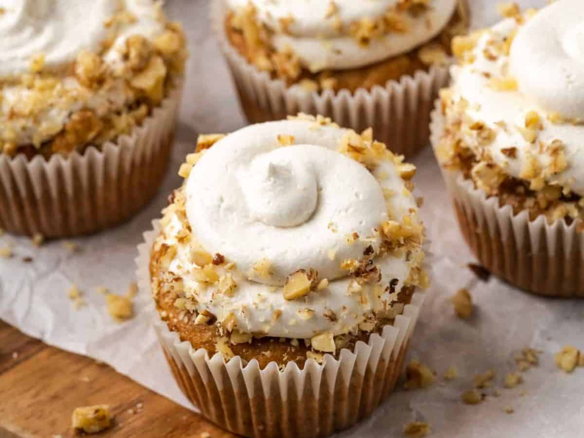 Gluten Free Carrot Cake Cupcakes with frosting and chopped nuts.