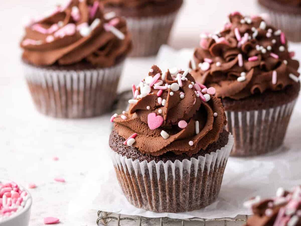 Gluten Free Chocolate Cupcakes topped with chocolate frosting and sprinkles.