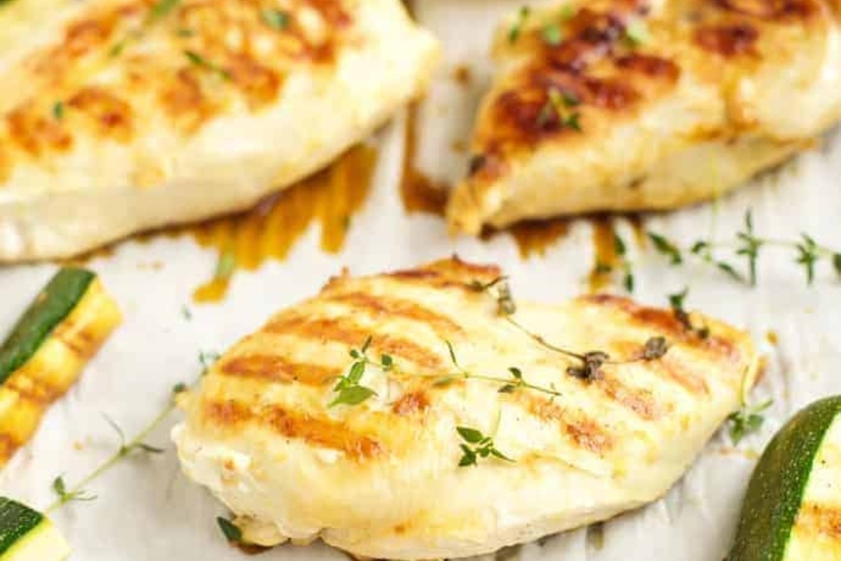 Grilled lemon chicken on a tray.