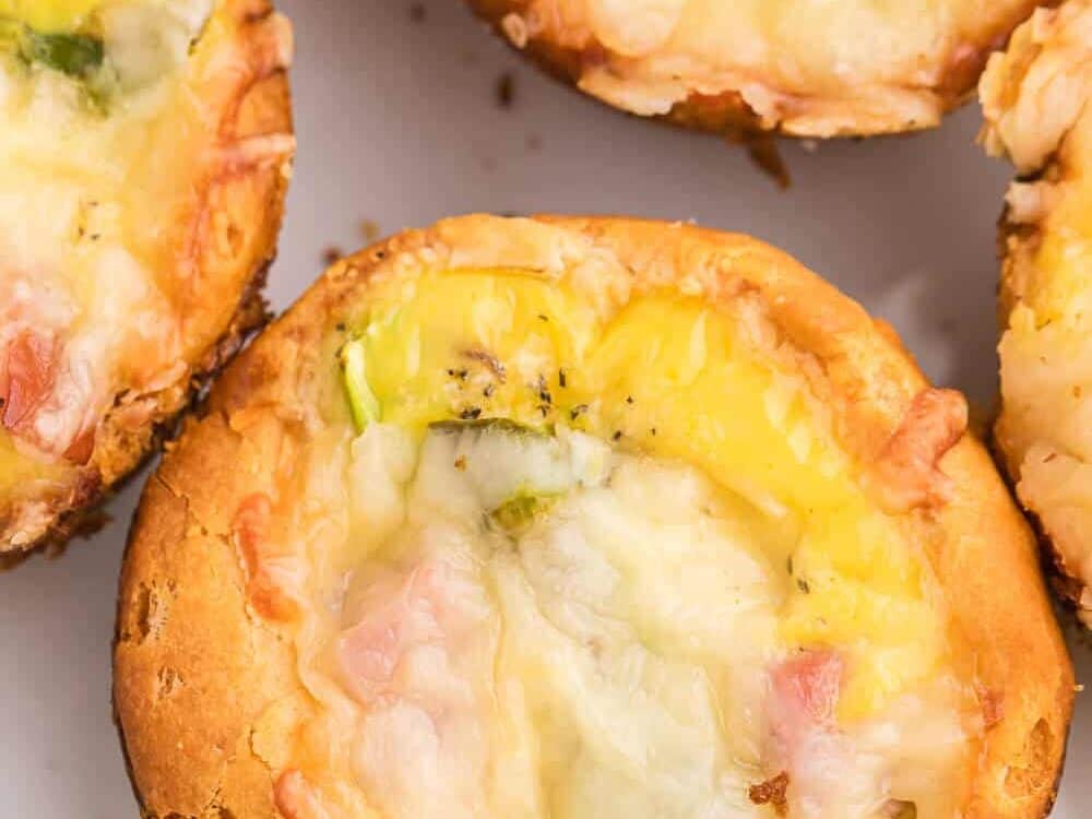Ham, asparagus, and Swiss cheese in biscuit cups.