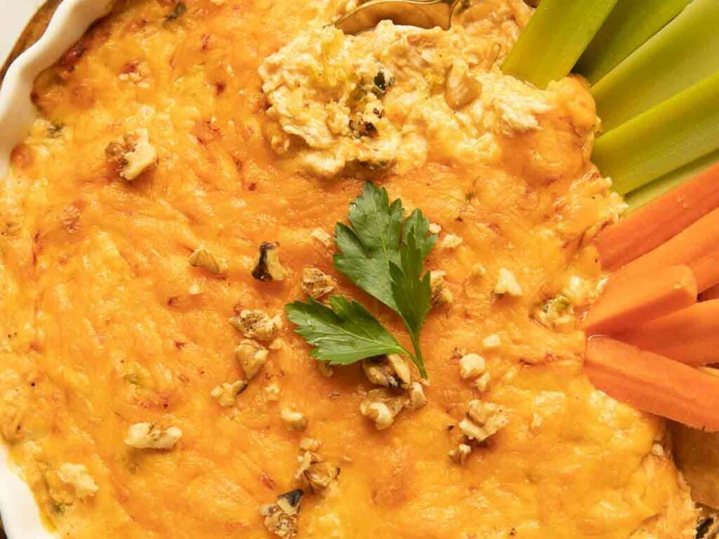 Cheesy buffalo chicken dip with vegetables.