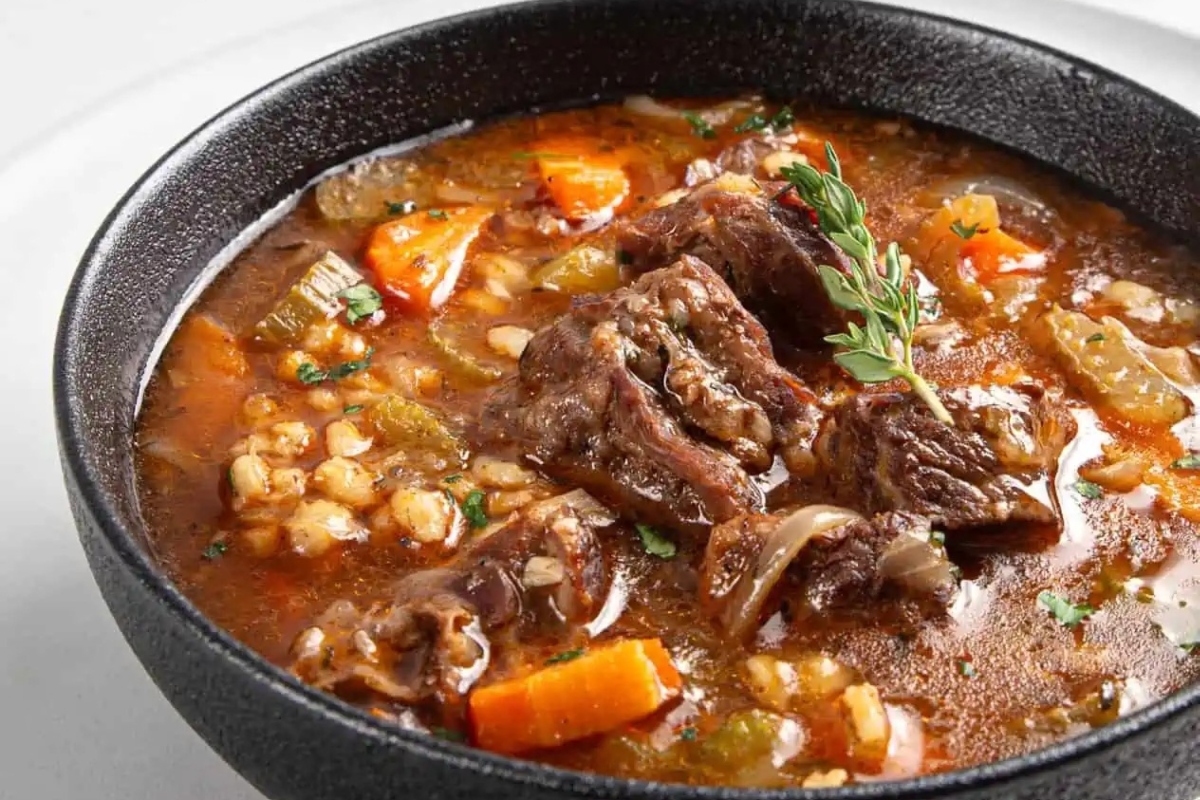Beef barley soup with carrots.