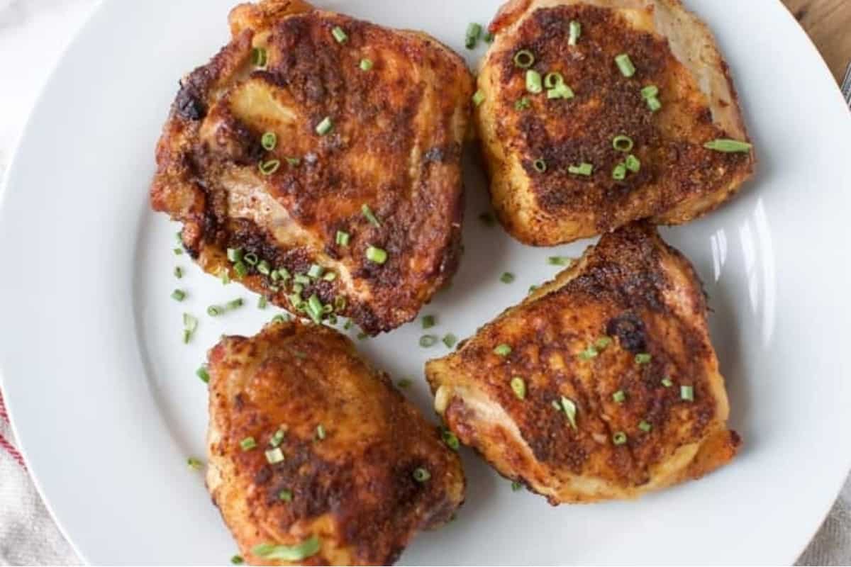 Chicken thighs on a plate.