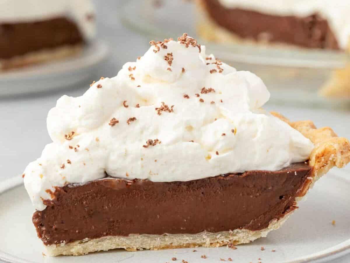 A slice of old fashioned chocolate pie on a plate.