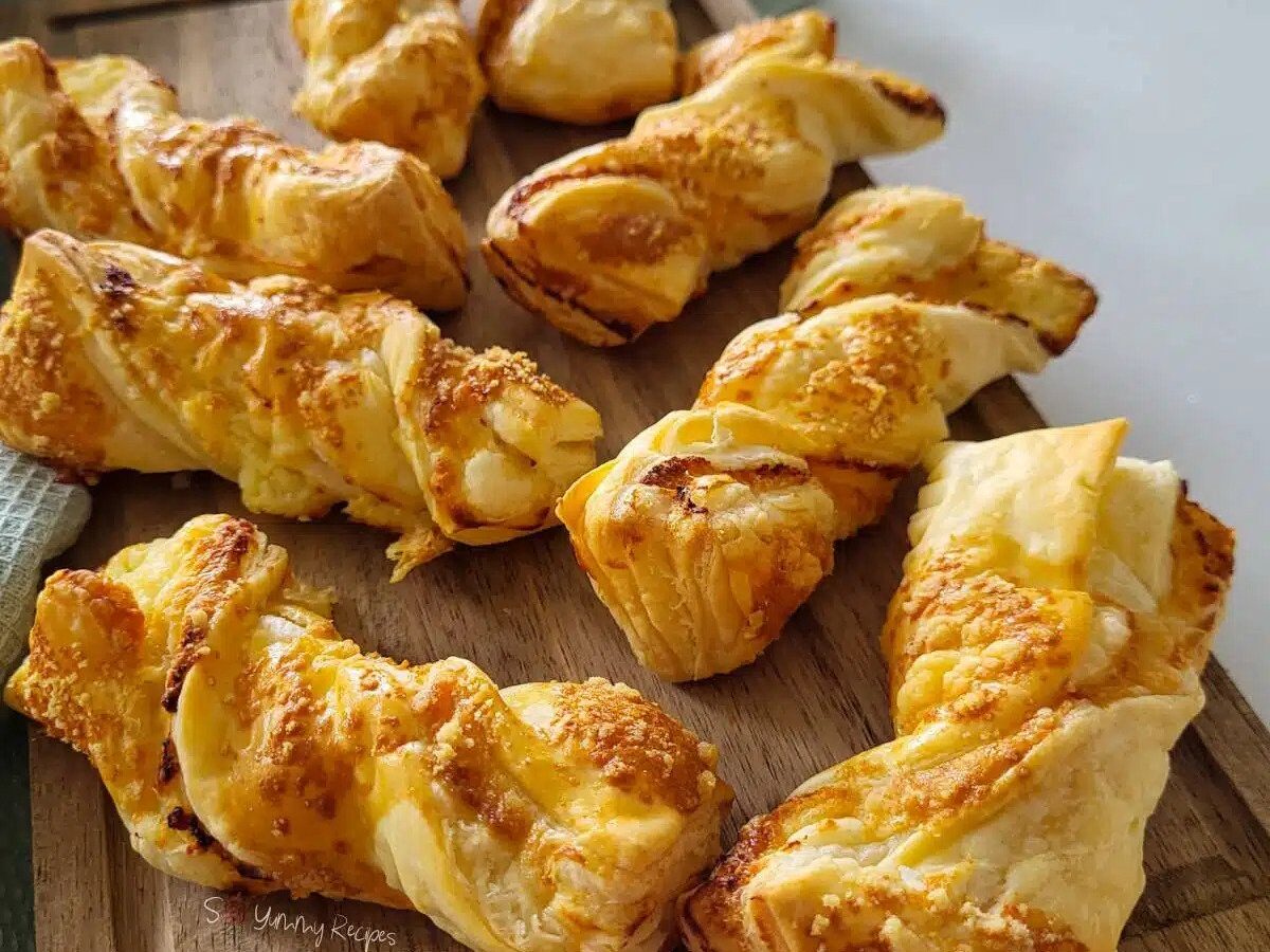 Puff pastry straws on a wooden board.