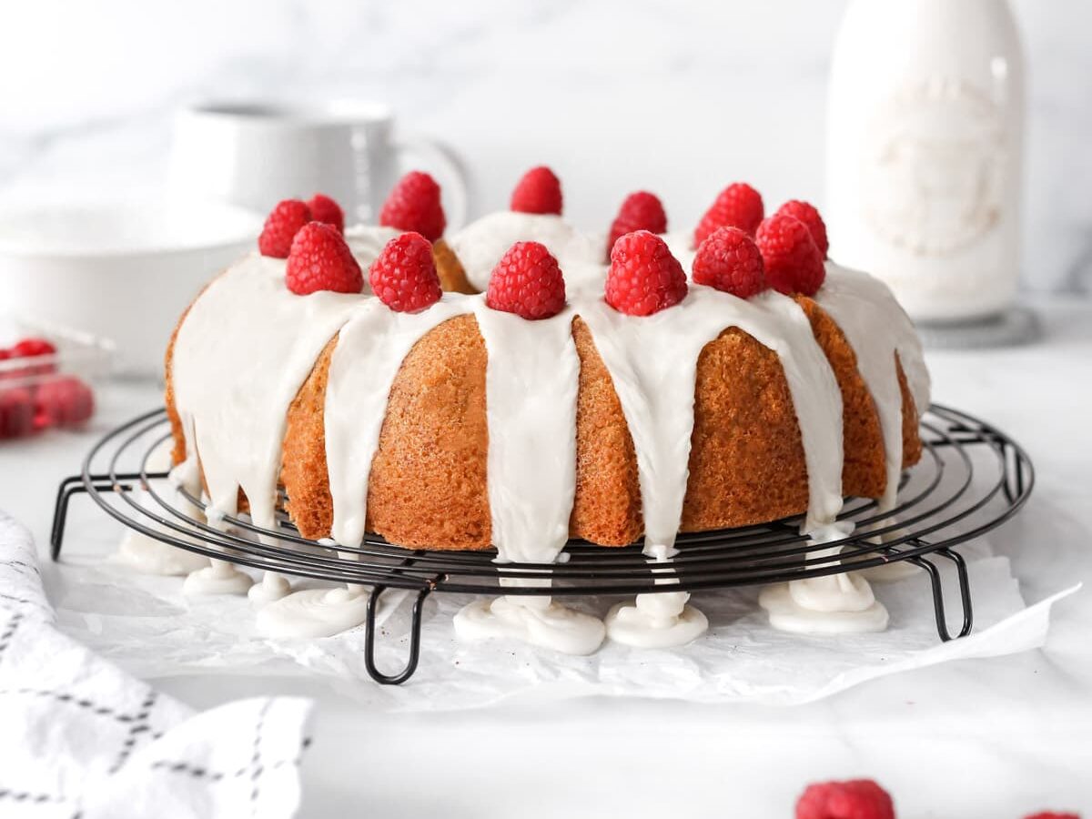 Raspberry White Chocolate Bundt Cake with icing on a cooling rack. 