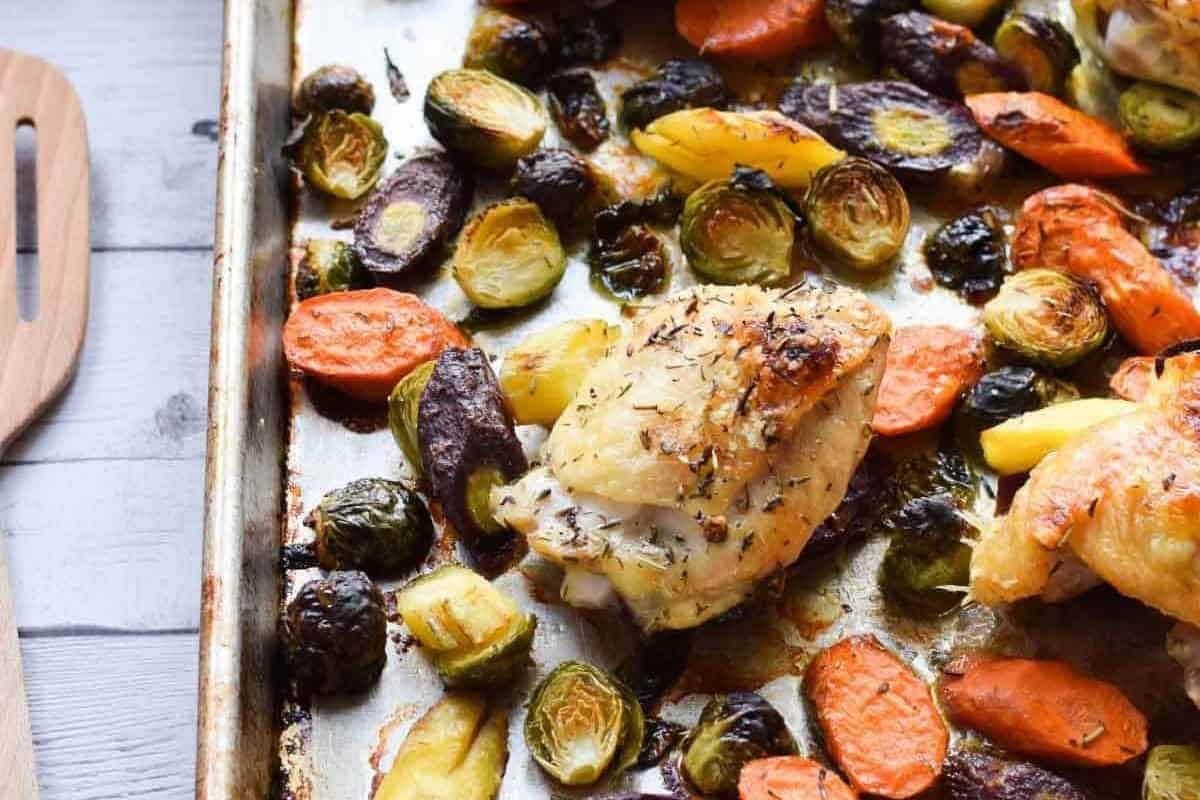 Chicken and brussel sprouts on a tray.