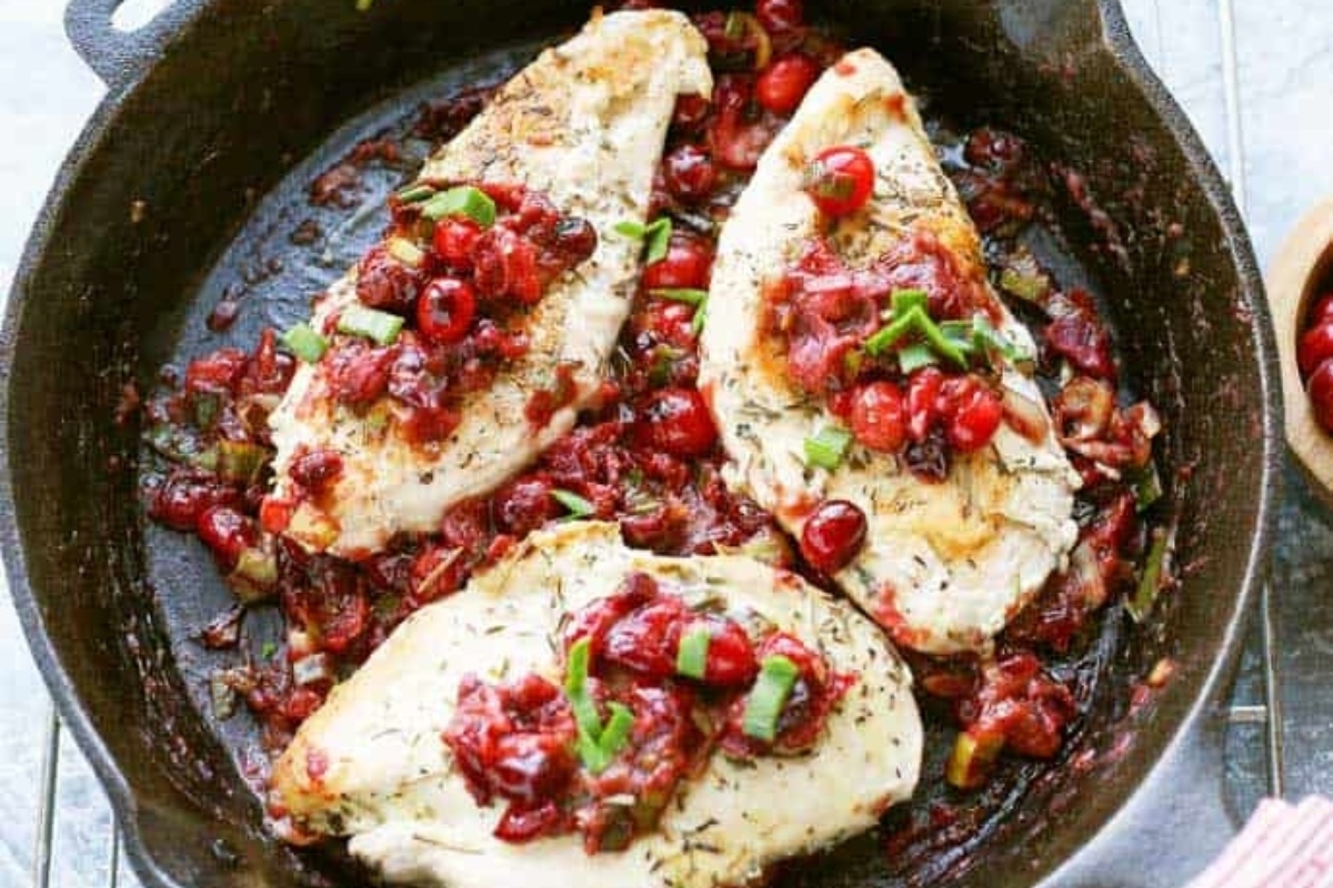 Cranberry leek chicken in a pan.