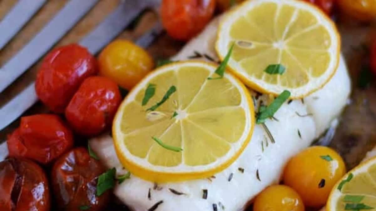 Roasted cod with tomatoes on the side.
