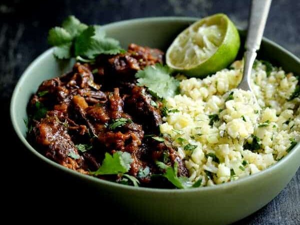 Slow Cooker Beef Short Ribs Barbacoa with Cilantro Lime Cauliflower Rice in a bowl.
