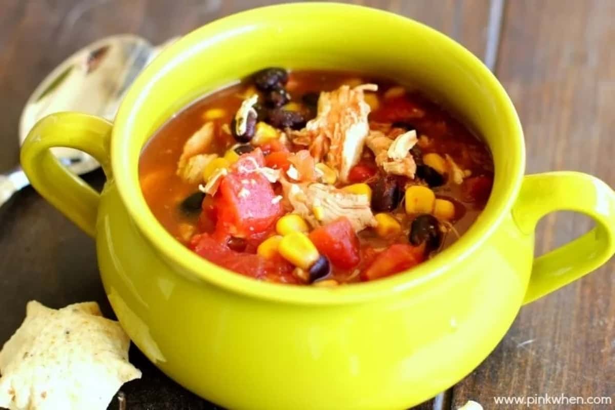 Chicken soup made with taco seasonings, black beans and chunks of tomato.