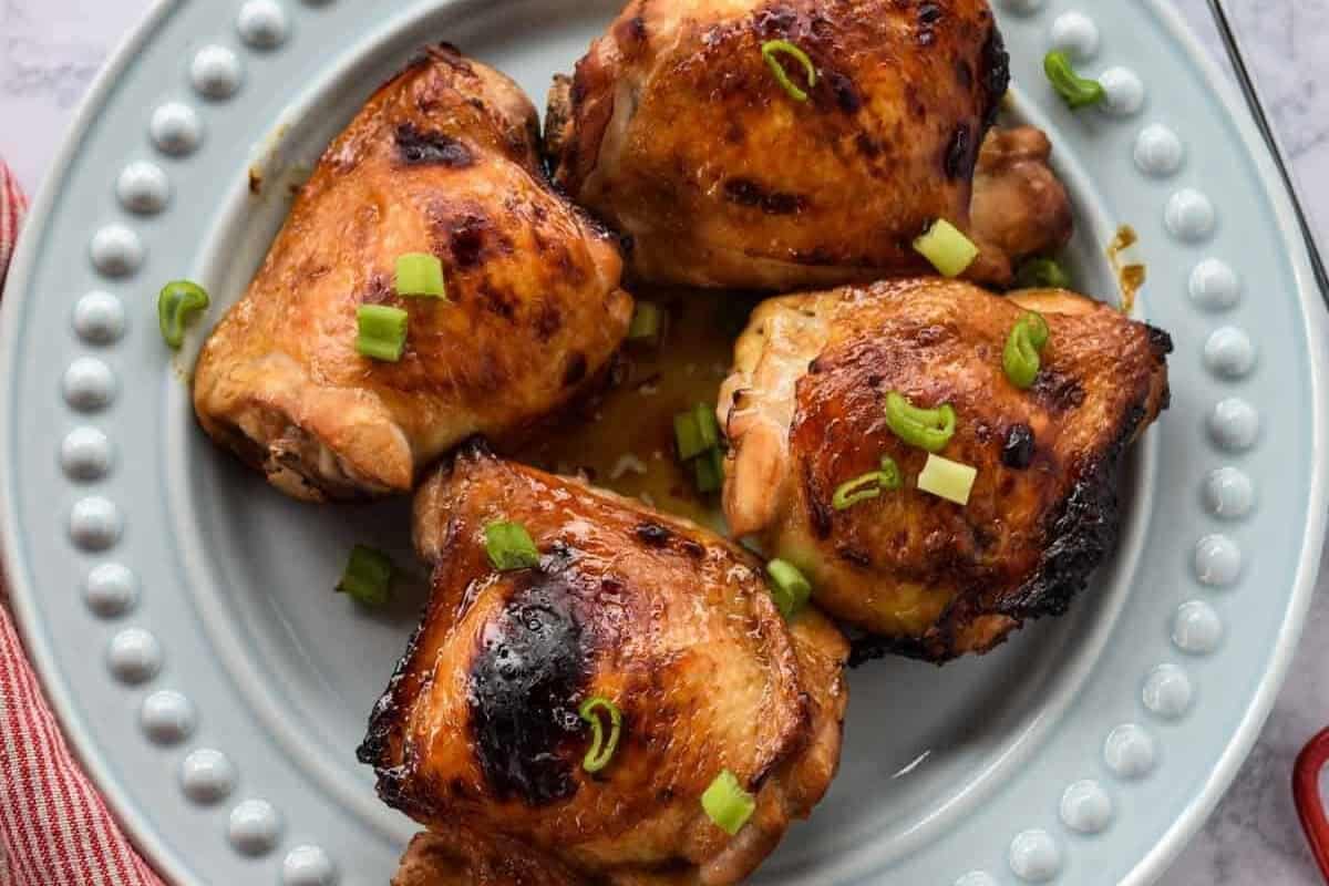 Soy glazed chicken thighs on a plate.