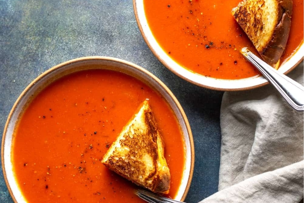 Bowls of tomato soup with grilled cheese.