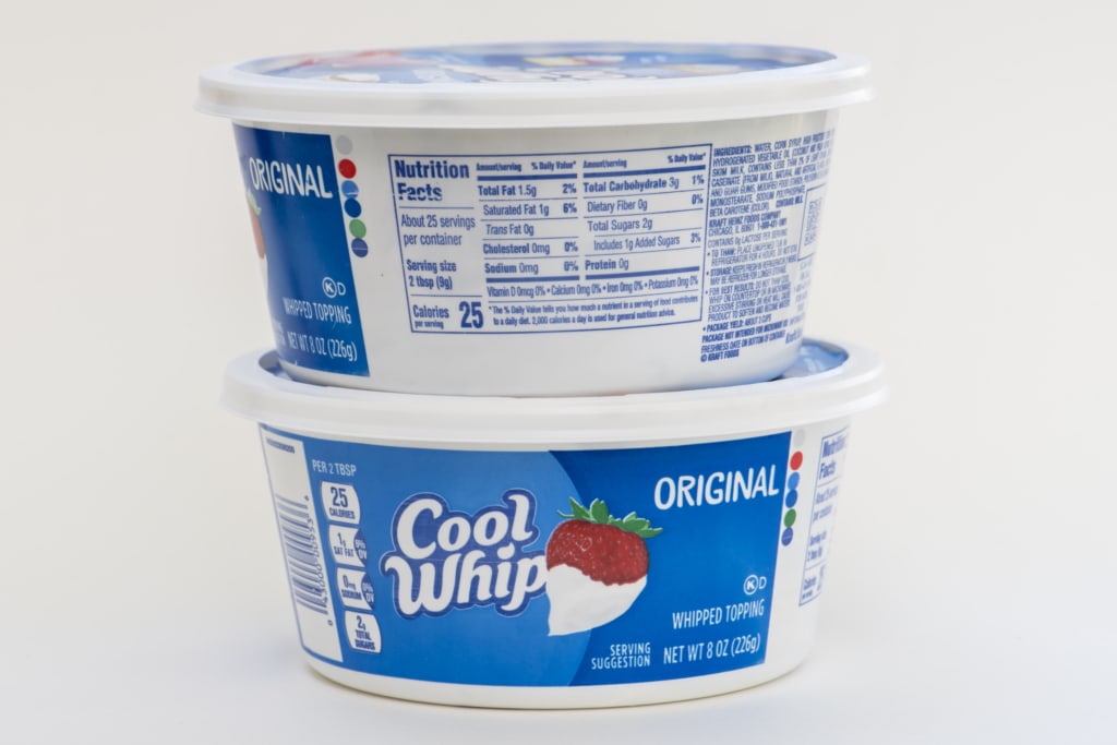 Cool whip topping on white background with nutrition fact label.
