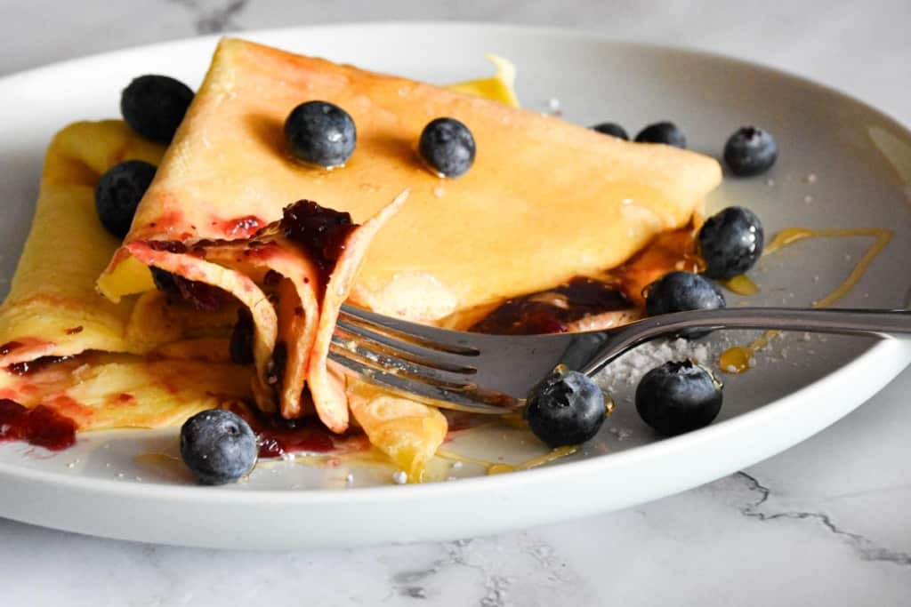 sourdough crepe with berries on a plate.
