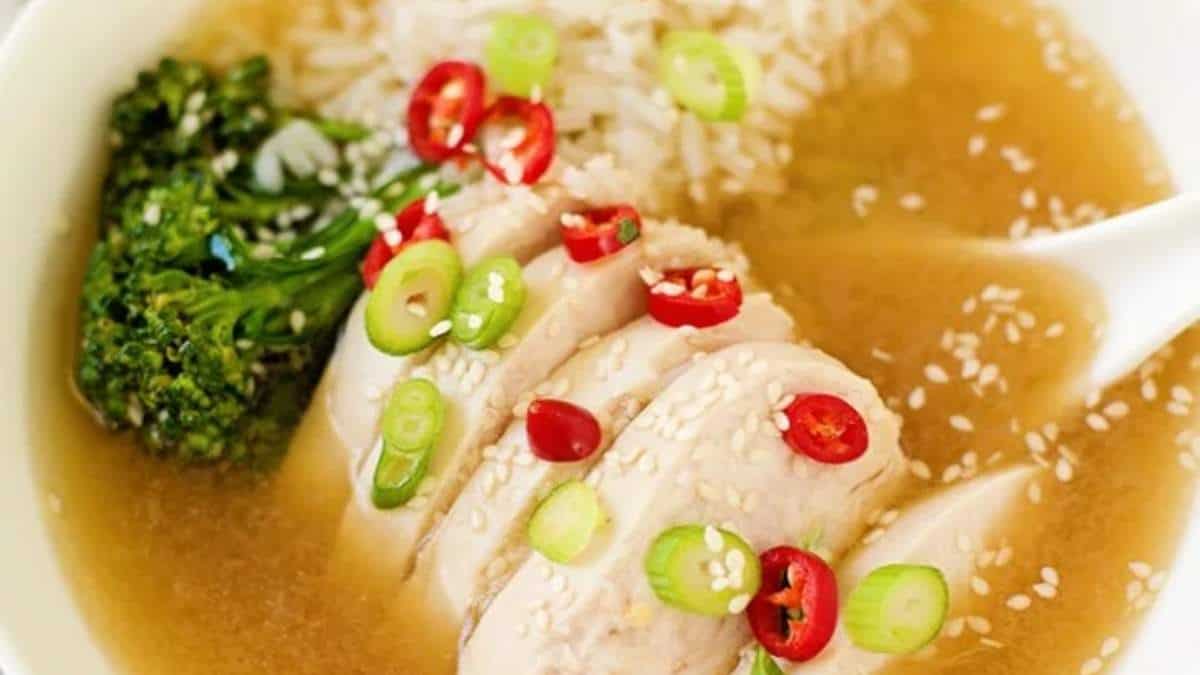 A flavorful bowl of chicken soup with tender bites of chicken, accompanied by steamed rice and nutritious broccoli.