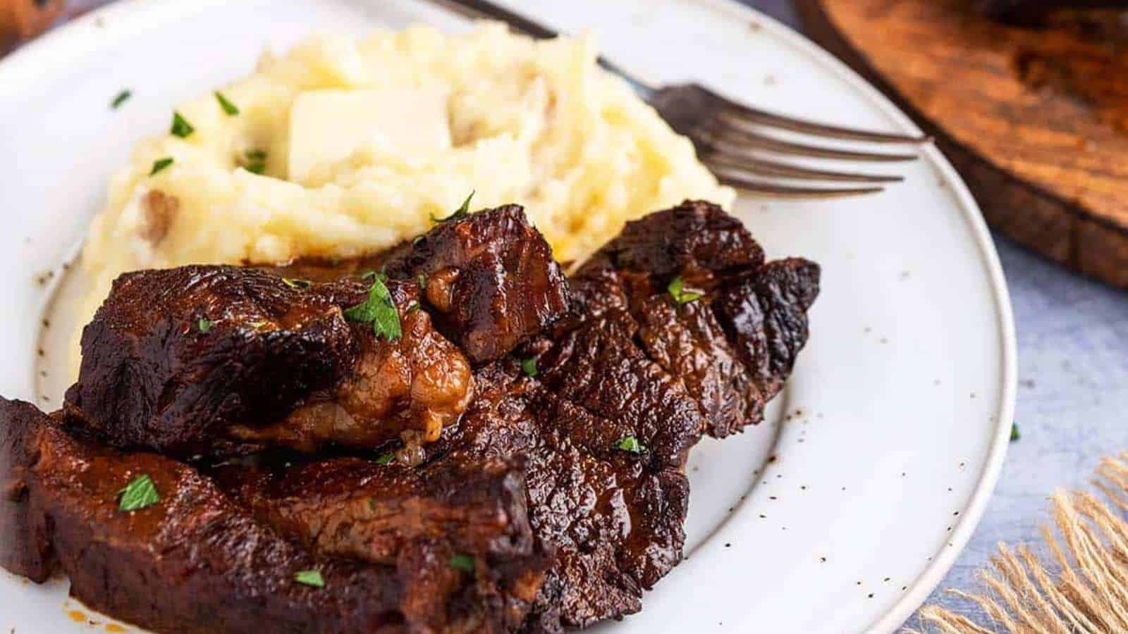 Ribs on a plate with mashed potatoes.