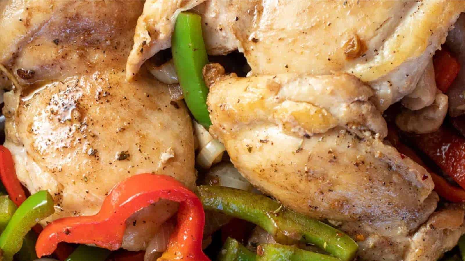A close up of chicken and peppers on a plate.