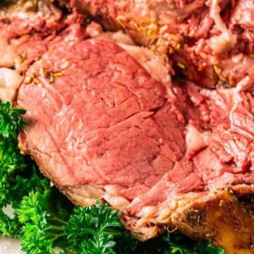 A comforting roast beef recipe shared with a sprinkle of parsley on a plate.