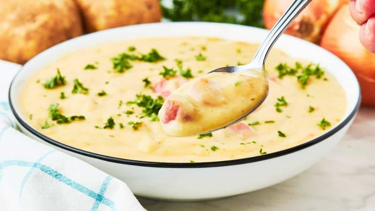 A hearty bowl of ham and potato chowder, perfect for a comforting meal on a chilly day.
