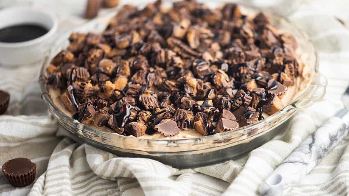 Decadent chocolate peanut butter pie in a glass dish.