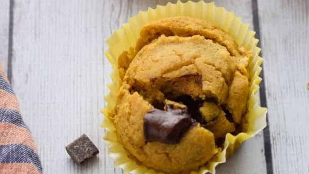 Pumpkin chocolate chip cookies on a wooden table, perfect for fall baking.