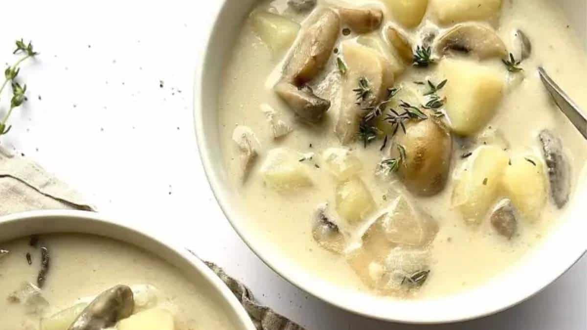         Soup recipe with mushroom and potato, garnished with sprigs of thyme.