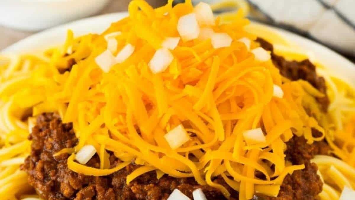 A hearty plate of spaghetti with chili and cheese topping, perfect for those who love comforting recipes.