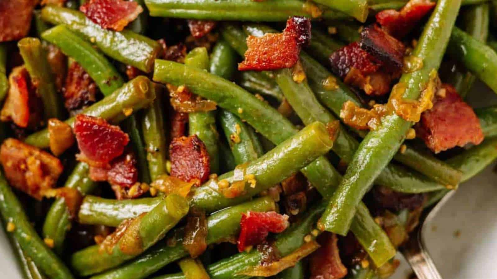 A close up of green beans with bacon.