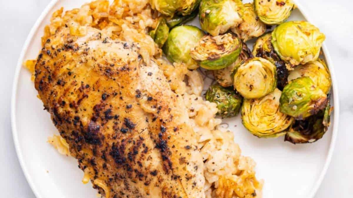 Roasted chicken and brussels sprouts on a plate.