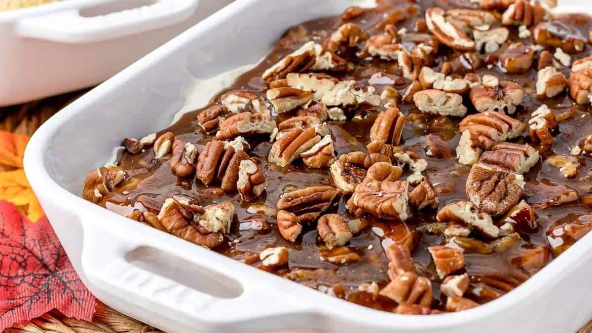 A shared dish with pecans and caramel on it.