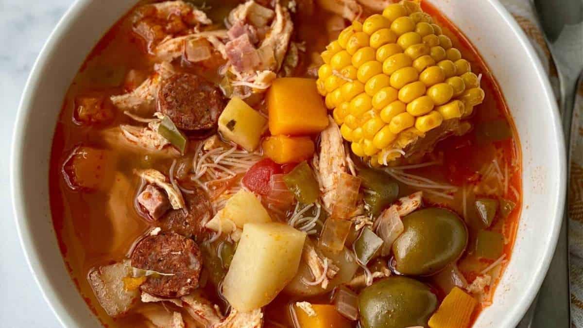 A bowl of soup with meat, vegetables and corn. Perfect for those looking for unique and delicious soup recipes!