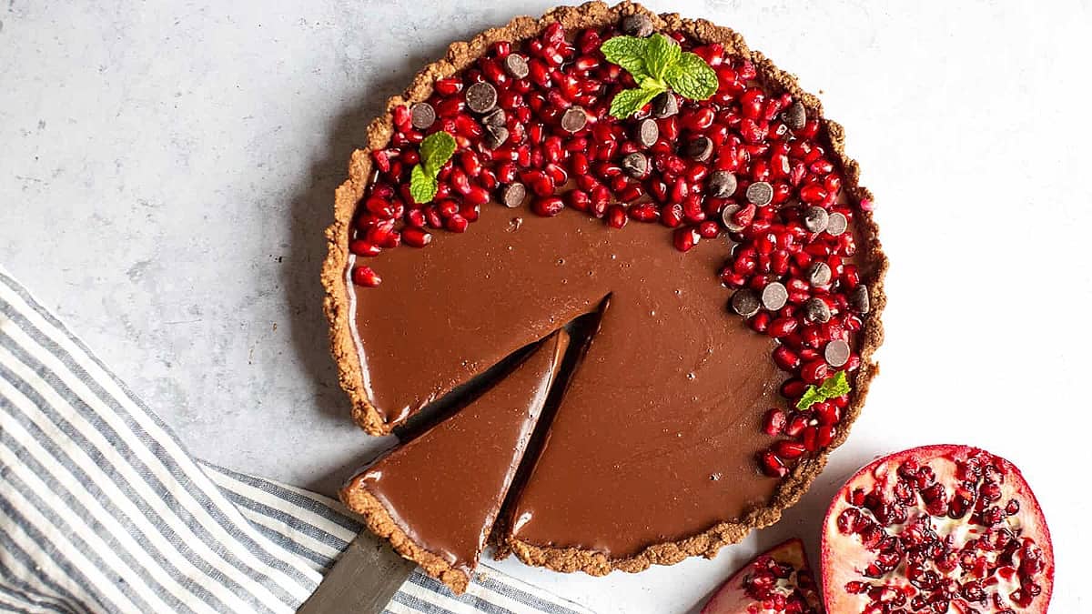 Chocolate pomegranate tart with pomegranate seeds, a sweet pie recipe.