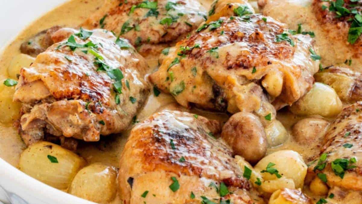 Chicken and potatoes in a white dish.