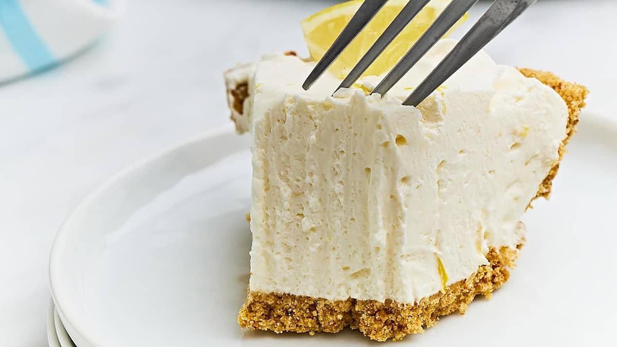A slice of lemon icebox pie on a plate.