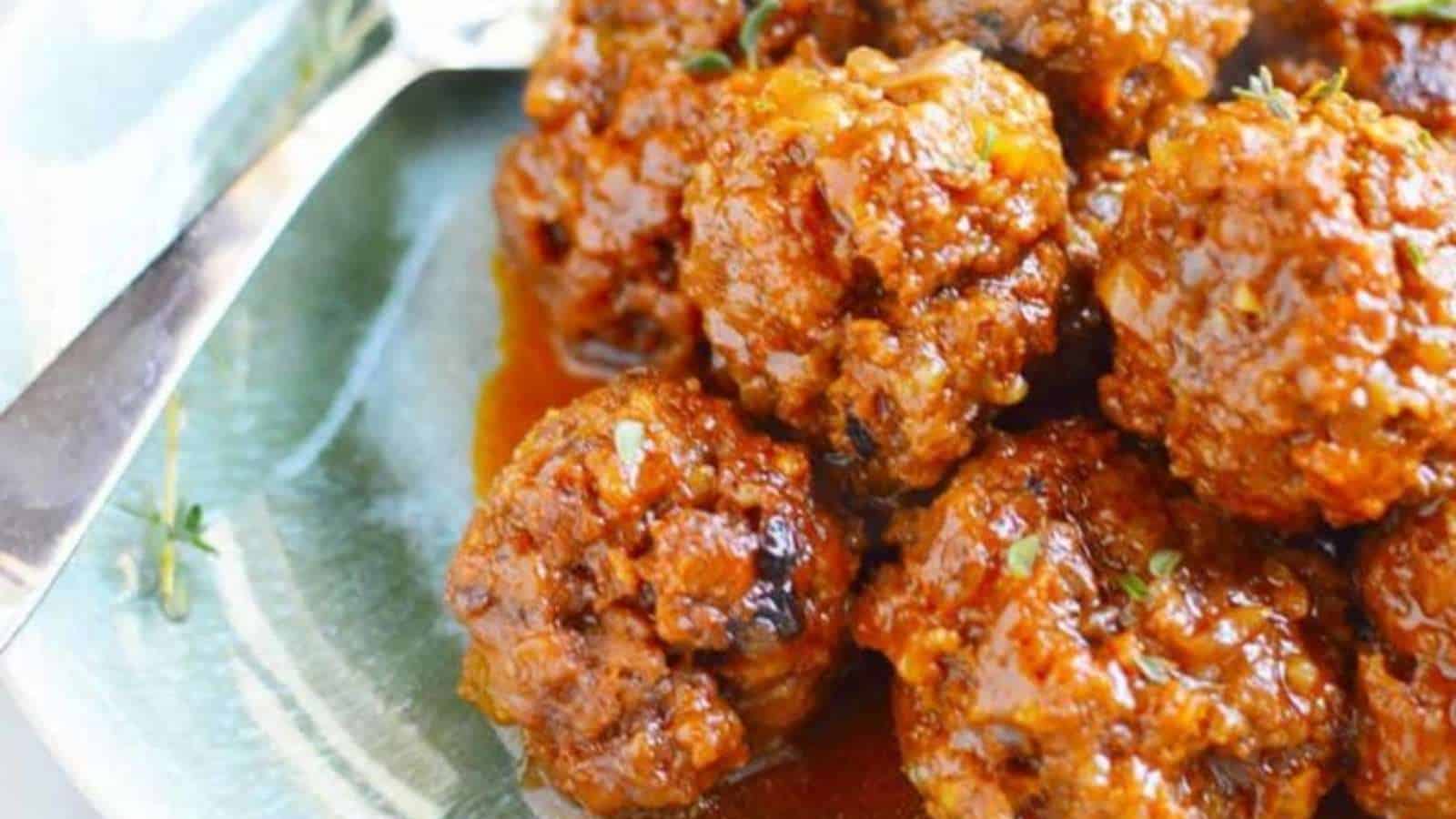 Meatballs in a sauce on a plate.