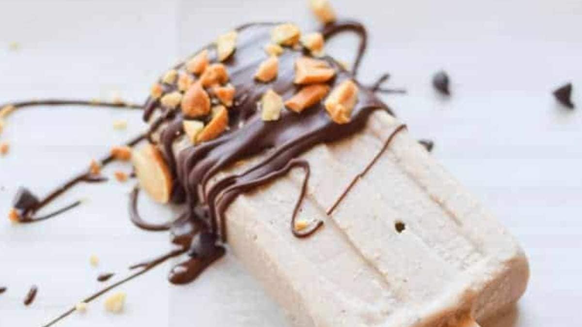 A shared round up of a no bake popsicle with chocolate and nuts on top.