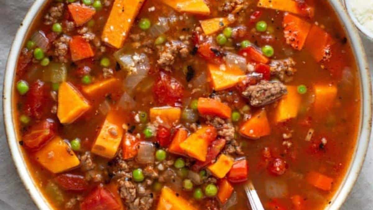 A comforting bowl of stew, rounded up with a perfect combination of meat, vegetables, and peas - an ideal dish for a shared meal.