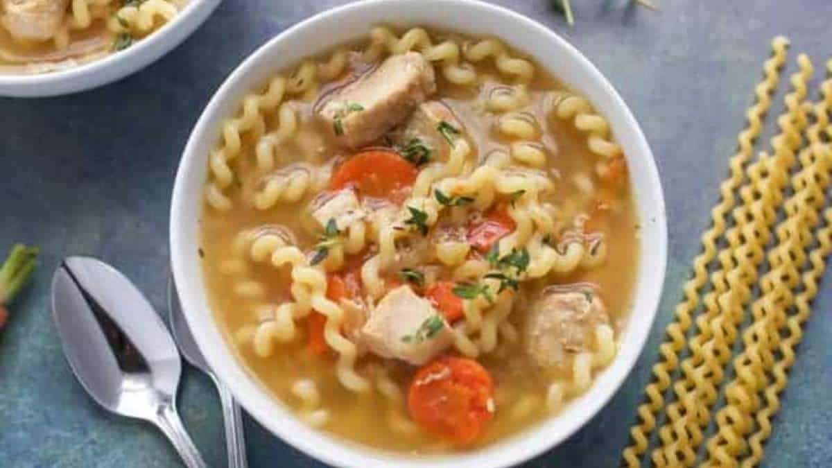 A comforting bowl of chicken noodle soup featuring tender noodles and savory carrots.