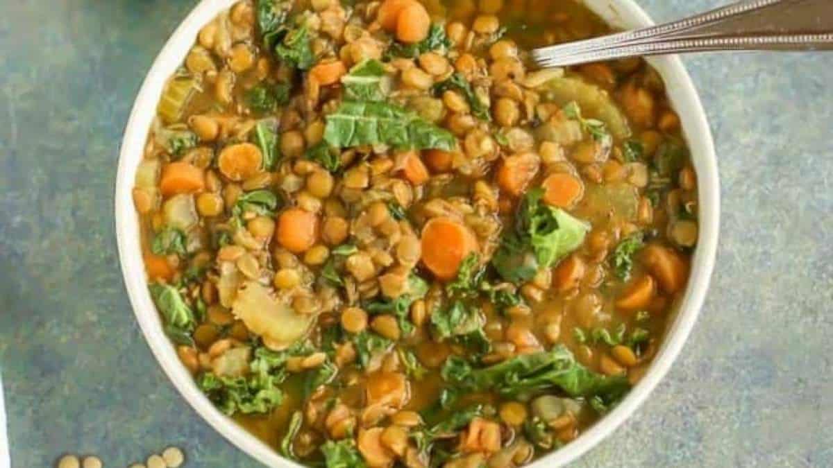 A bowl of lentil soup with a spoon.